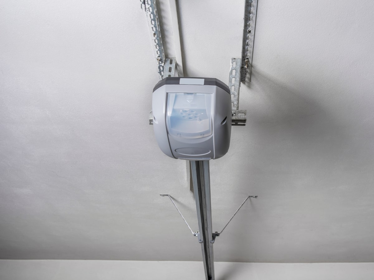 A garage door opener is mounted on a ceiling.