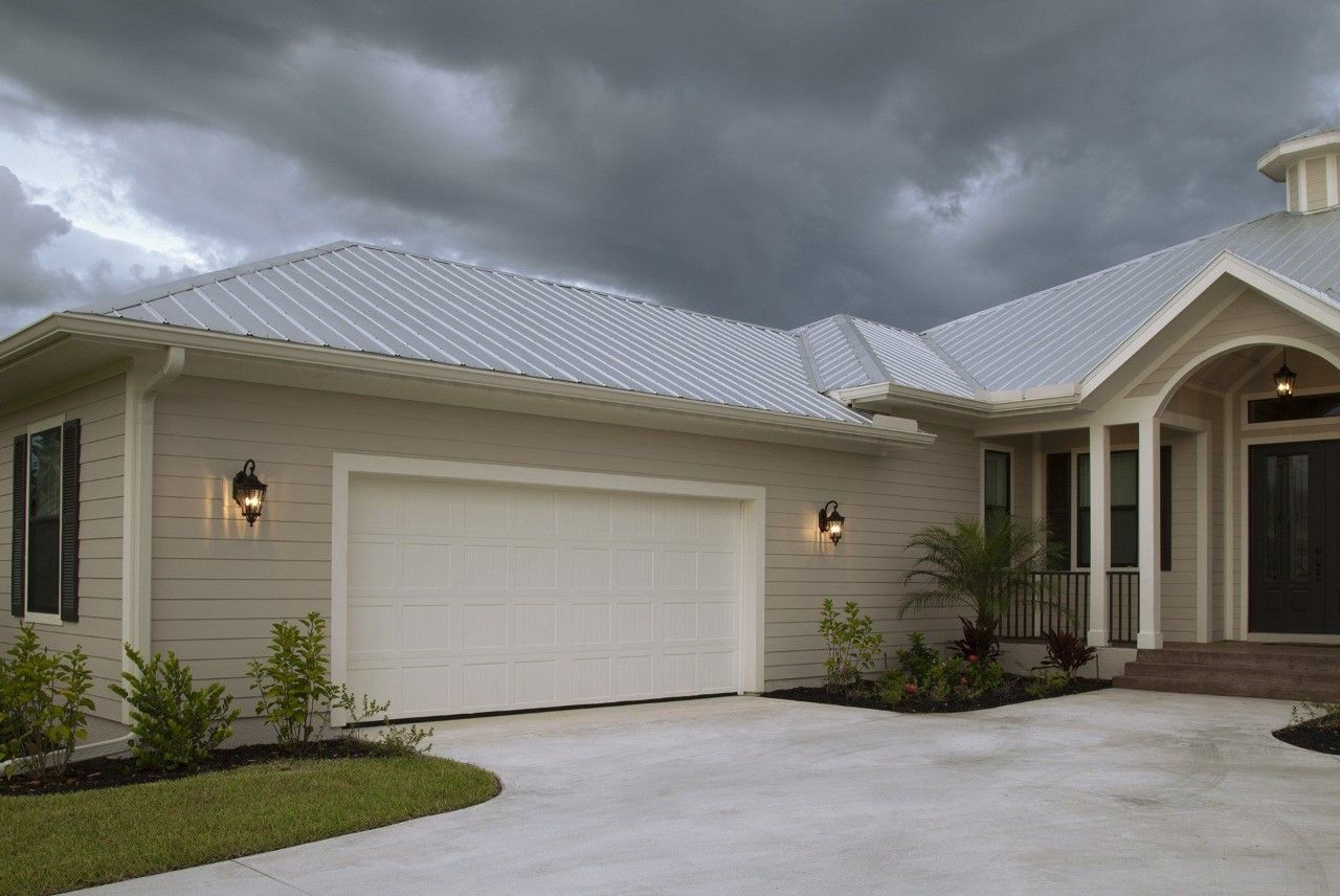 An exterior view of a home with a large white garage door.