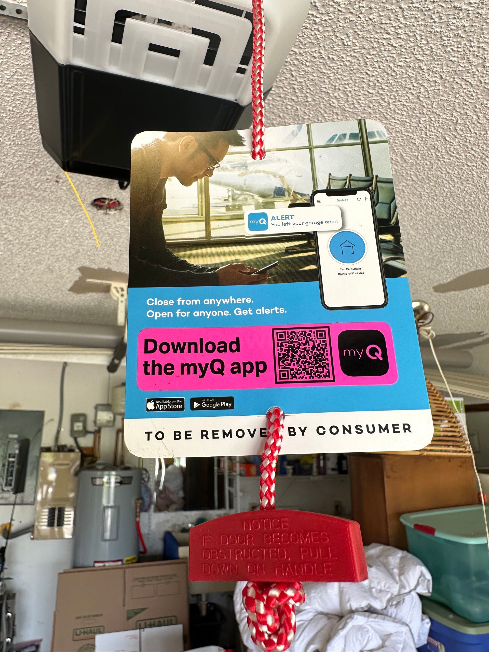 A person using a drill to install garage door tracks.